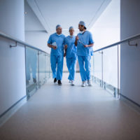 Surgeons interacting with each other in hospital corridor Surgeons interacting with each other in hospital corridor